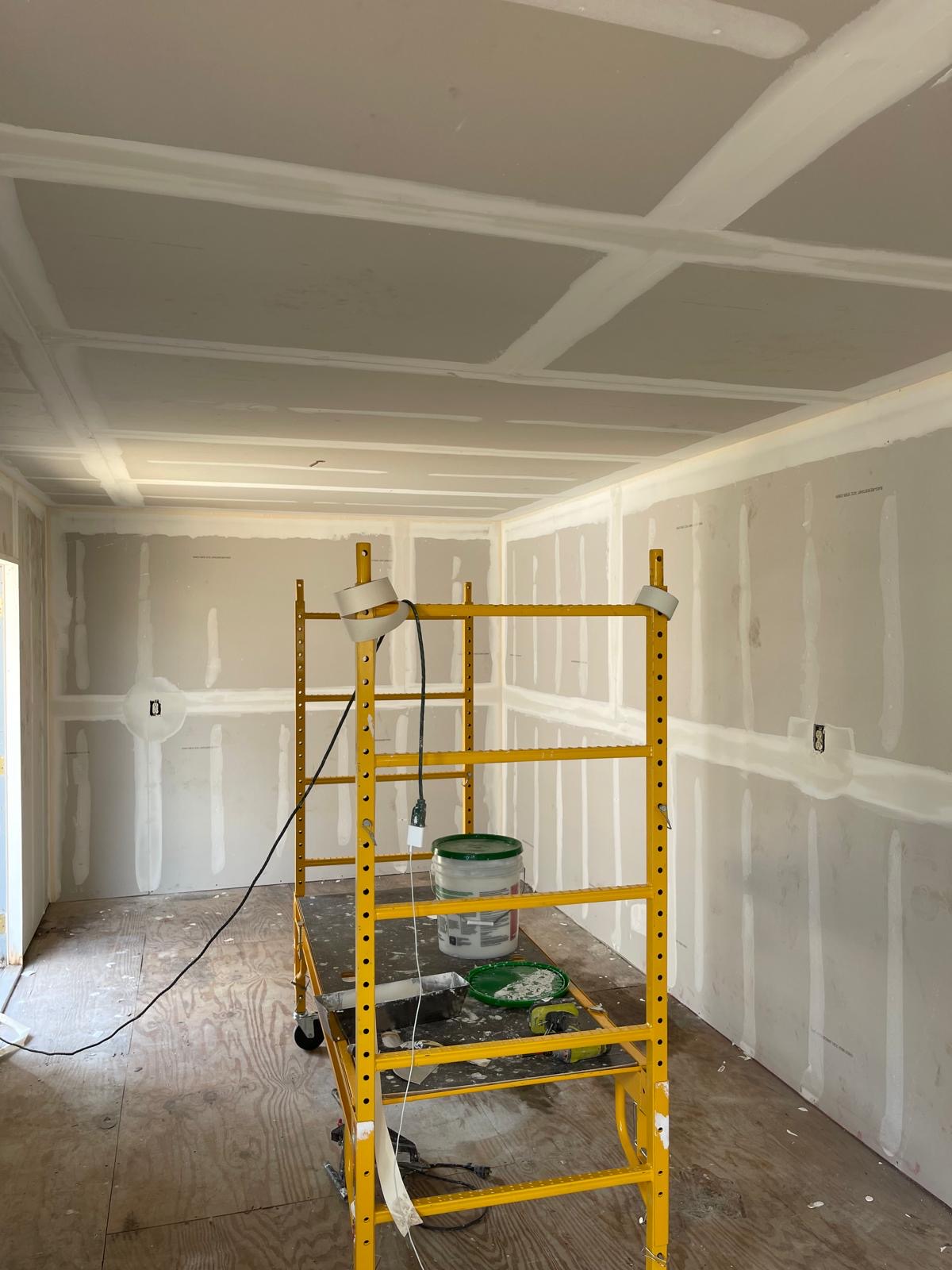 Drywall finishing with taped and mudded seams